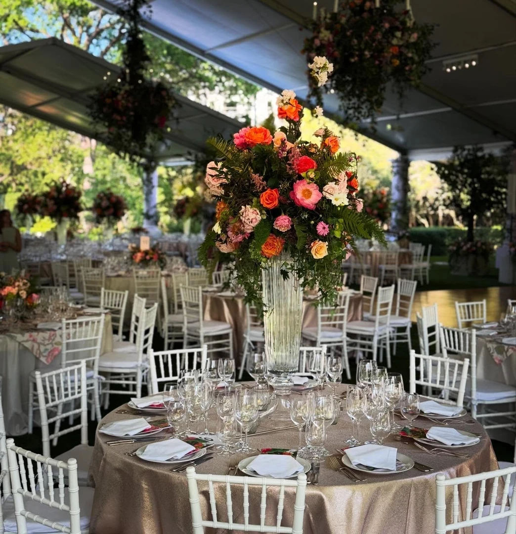 Reception tables set with tall floral centerpieces