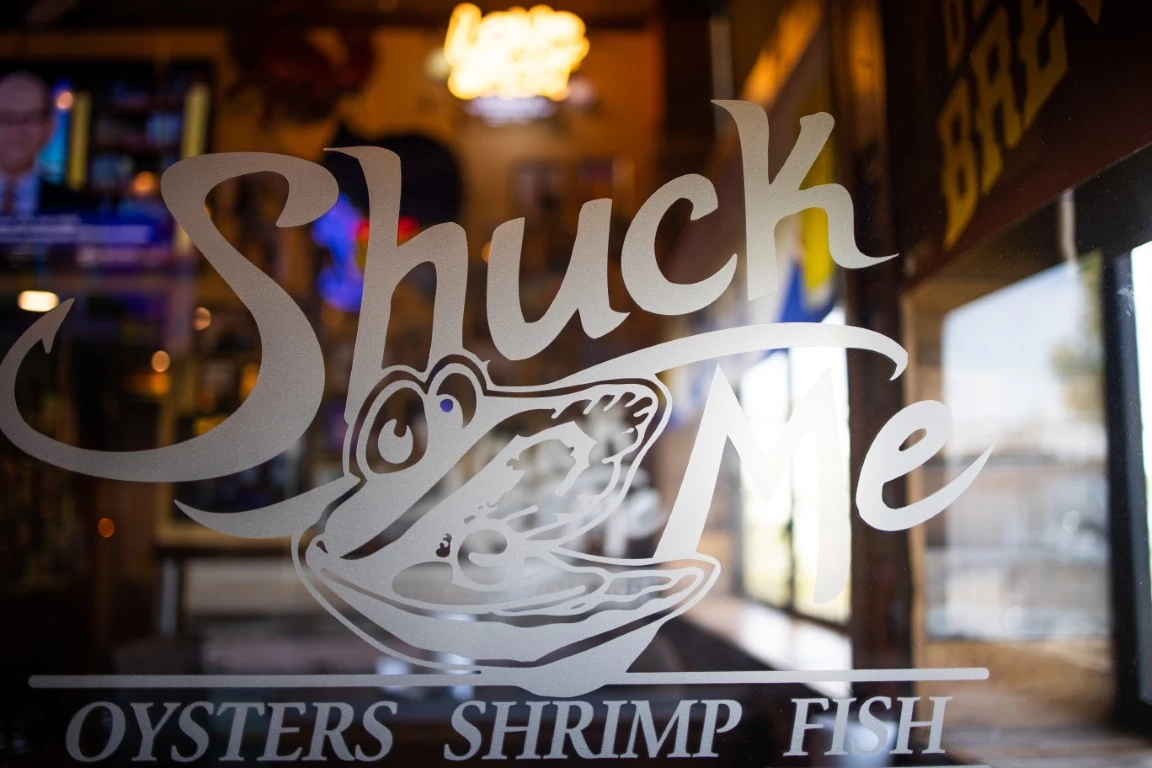 shuck me logo on glass