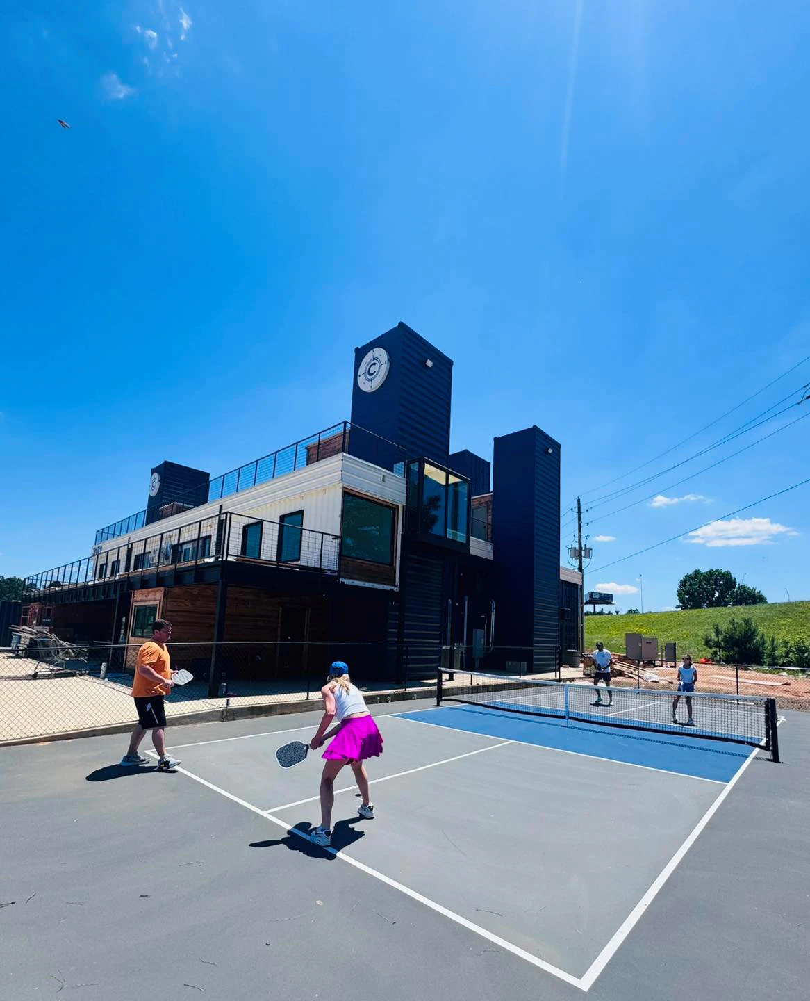 Players enjoying a game on the outdoor pickleball courts at Cargo