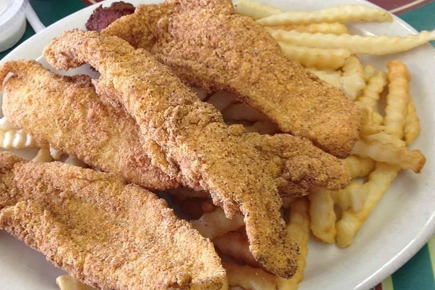Fried catfish fillets with crinkle-cut fries