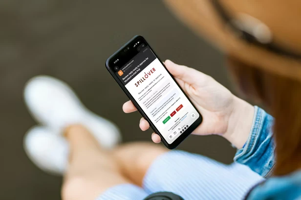 Restaurant owner reviewing an AI-generated review response on a phone