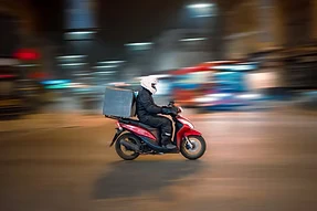 Motorcycle delivery rider in motion representing food delivery service