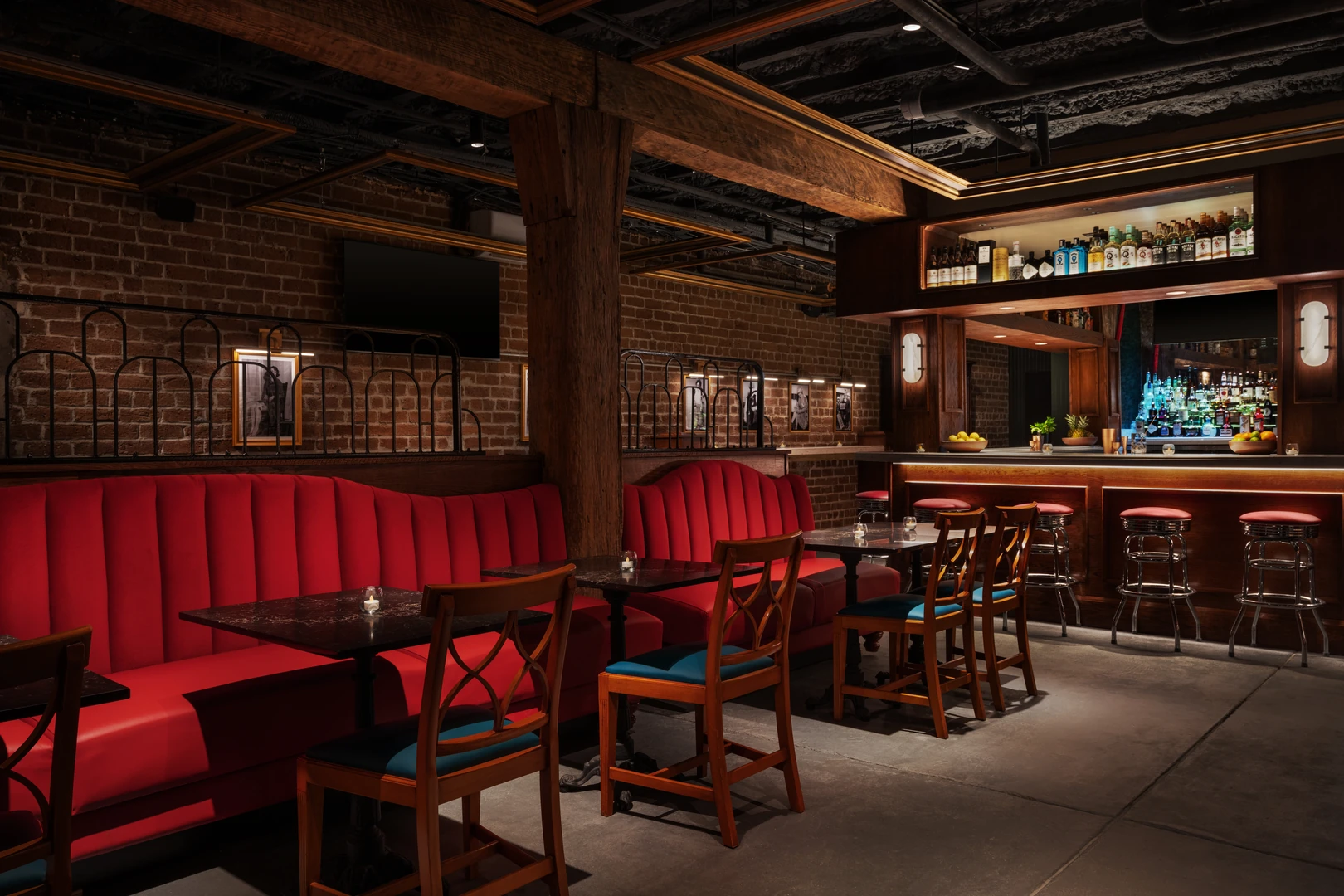 Red leather booths and brick walls inside The Bootlegger Speakeasy