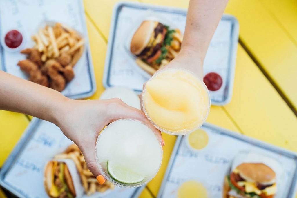 Frozen drinks served with burgers and fries at Brews N Paws