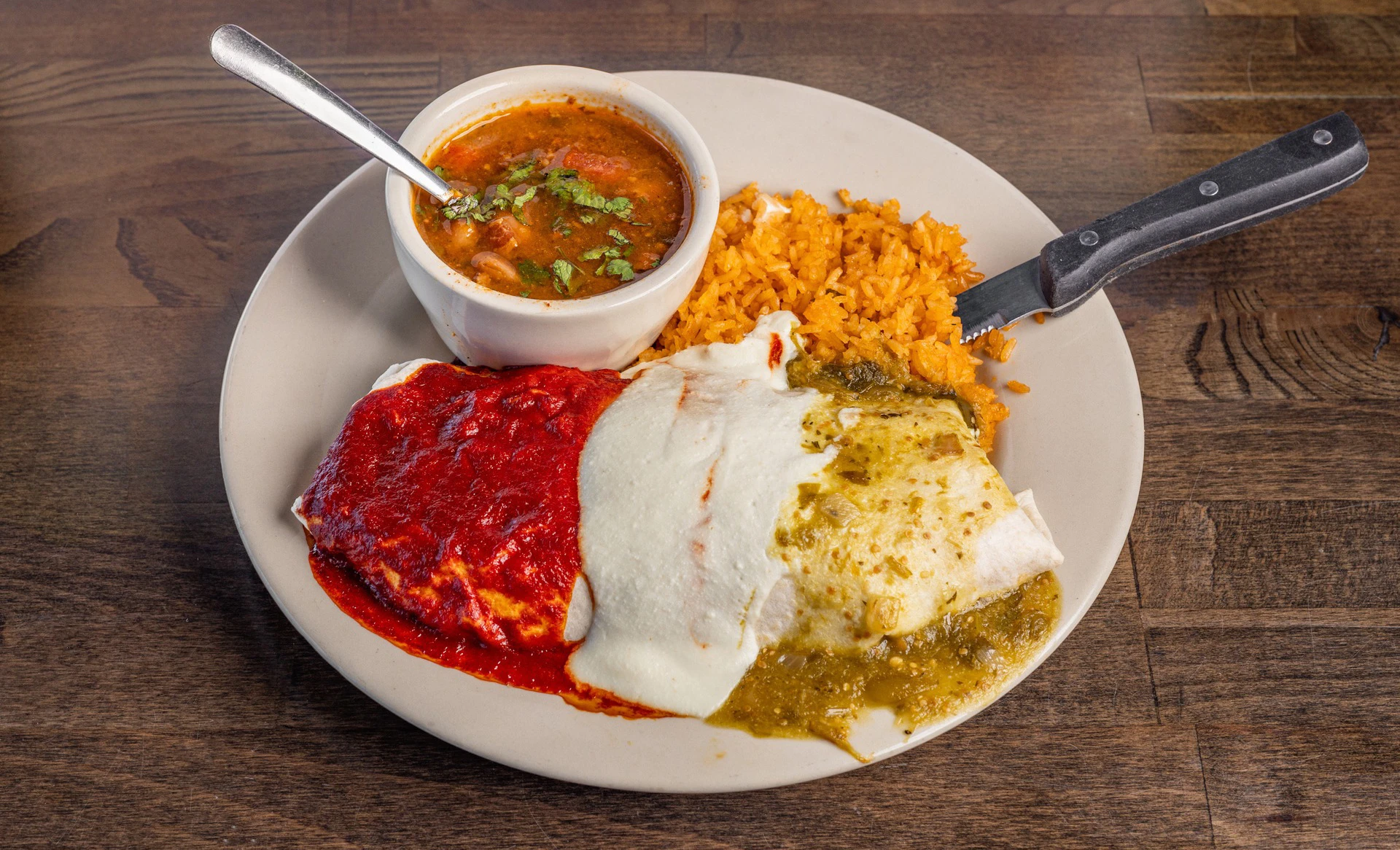 Three-sauce enchilada plate with rice and soup at Primo's Tex Mex Grille