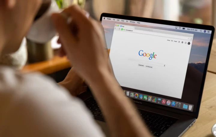 Person using laptop with Google search open