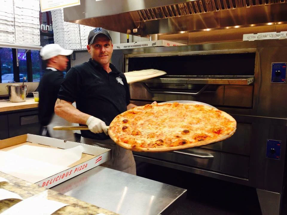 Chef serving up a fresh pizza