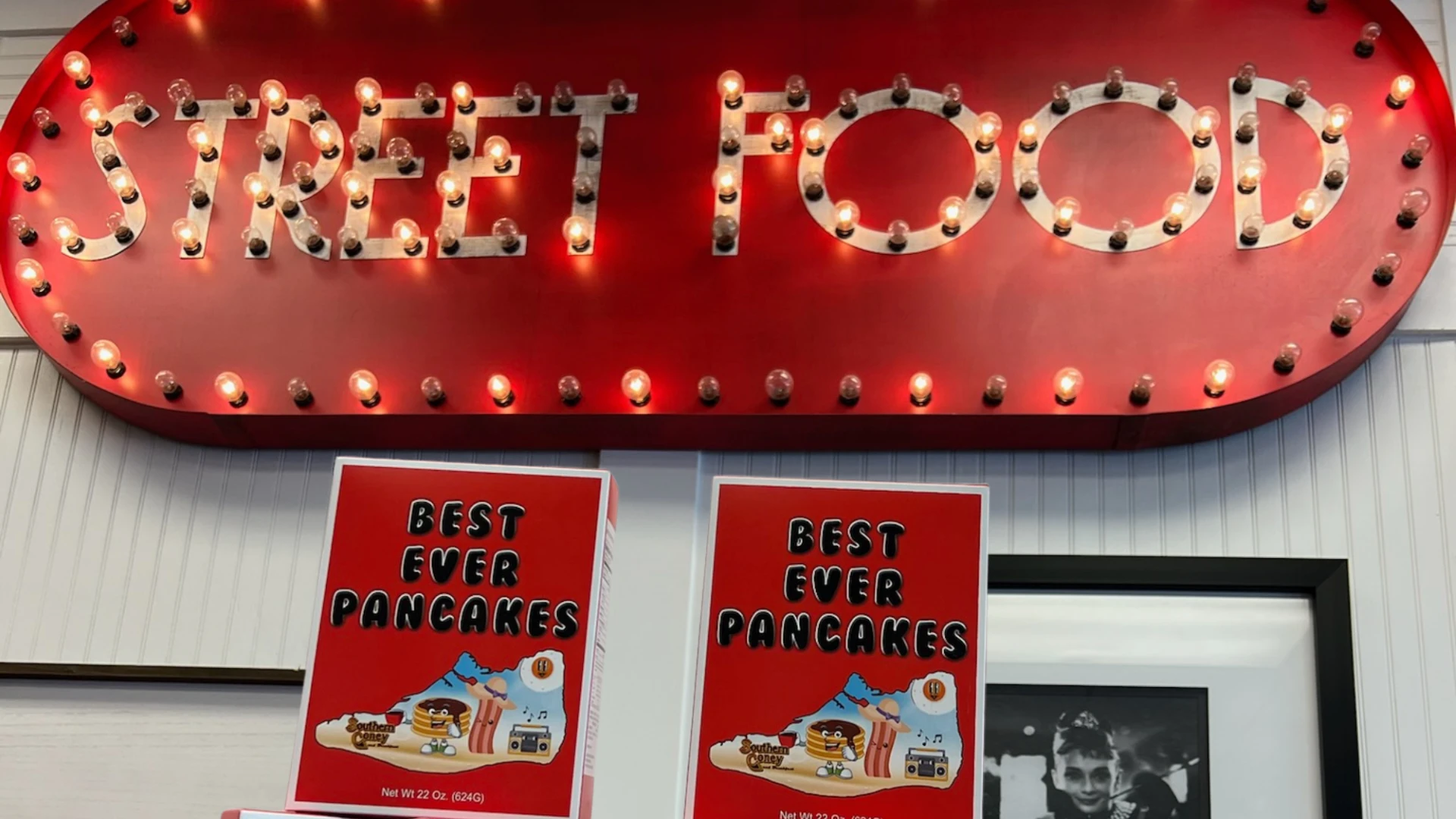Street Food diner sign with illuminated marquee lights and pancake mix boxes