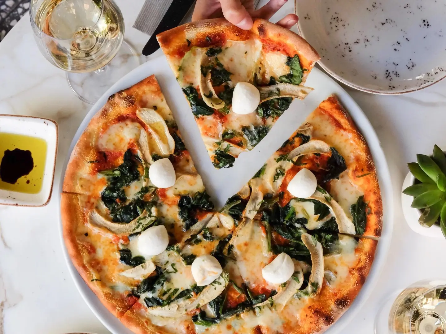 Pizza with a slice being taken