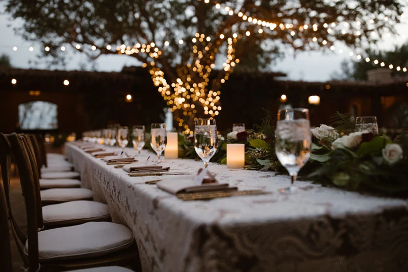 A rehearsal dinner planned and set under string lights