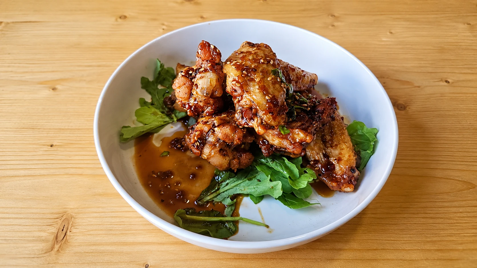 Glazed Sesame Chicken on Greens at the copper table