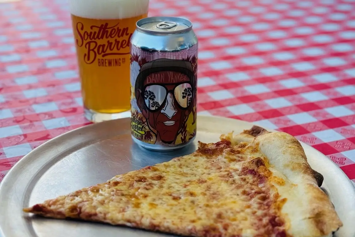 big pizza slice and a pint of beer