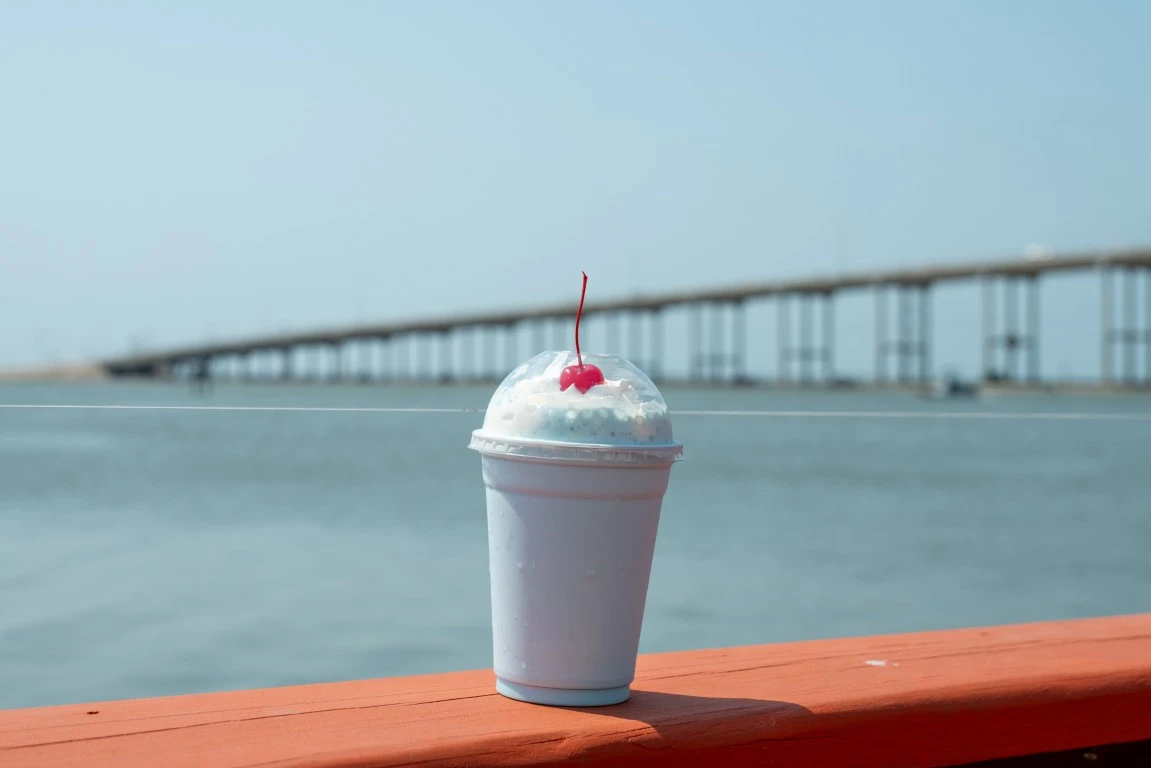 an oreo milkshake with the background of a bridge