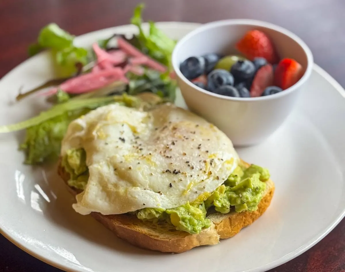 Plowman's Restaurant avocado toast brunch plate with egg and fruit