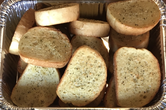 Toasted garlic bread slices.