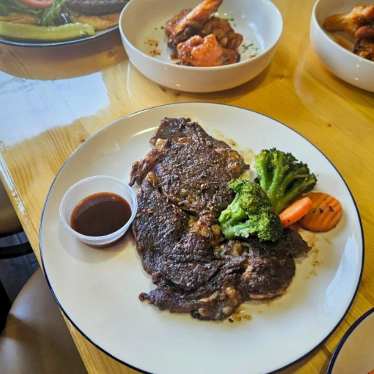 Grilled steak with broccoli and carrots at The Copper Table
