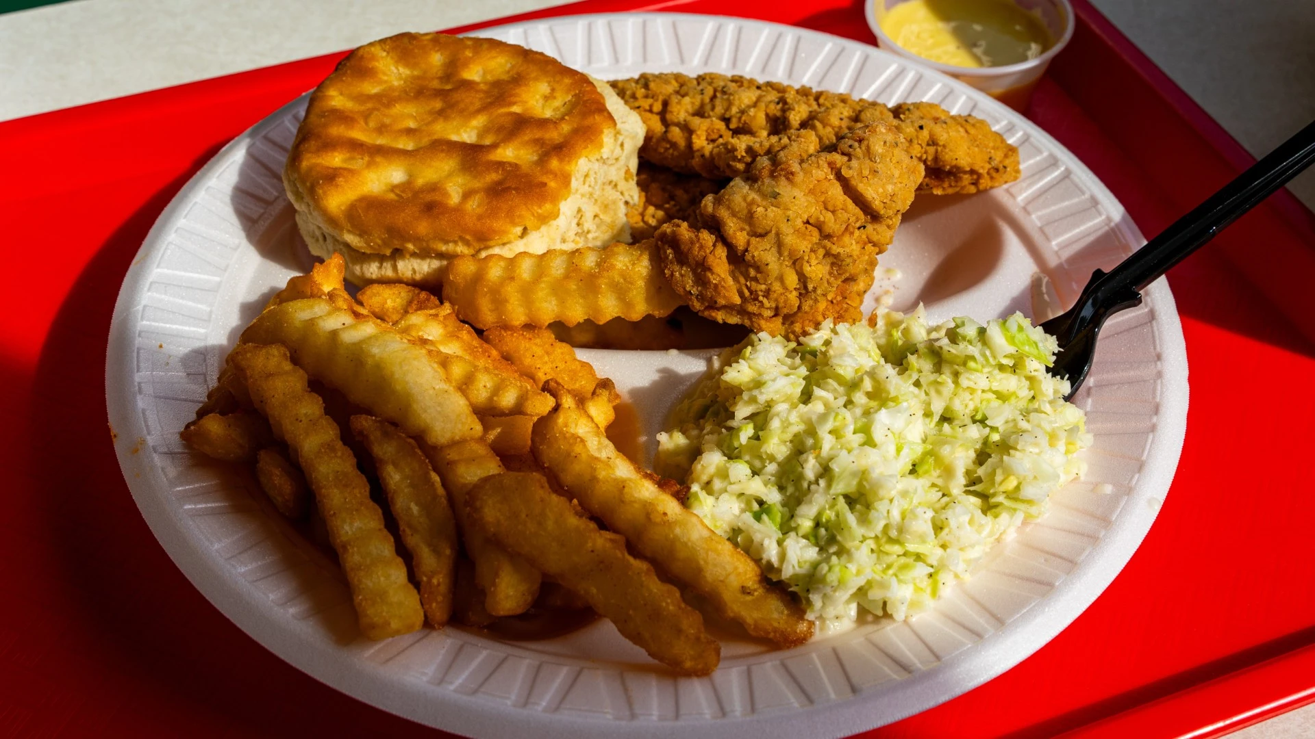 chicken fingers with fries, coleslaw, and biscuit