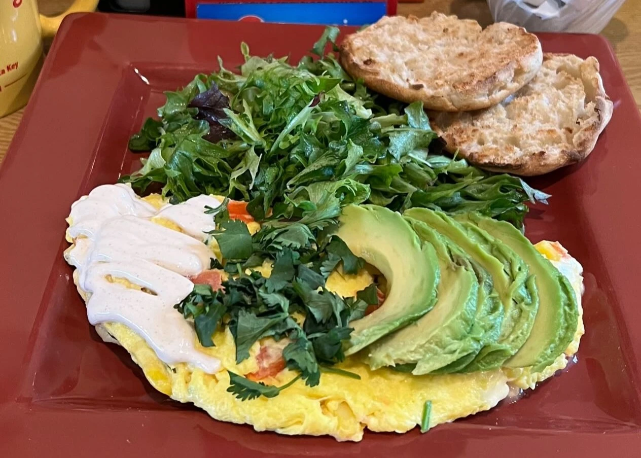 egg breakfast with avocados, spinach, and sausage patties