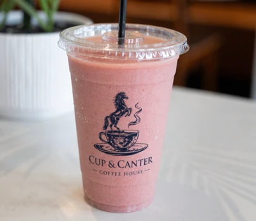 Cup and Canter strawberry smoothie in a clear cup