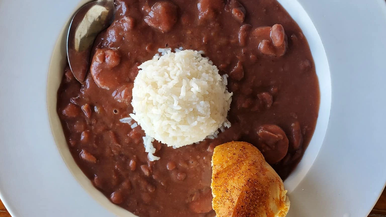 Red beans and sausage served over white rice with cornbread.