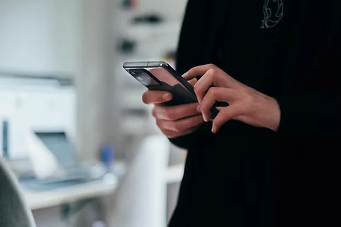 Person holding a phone in a restaurant