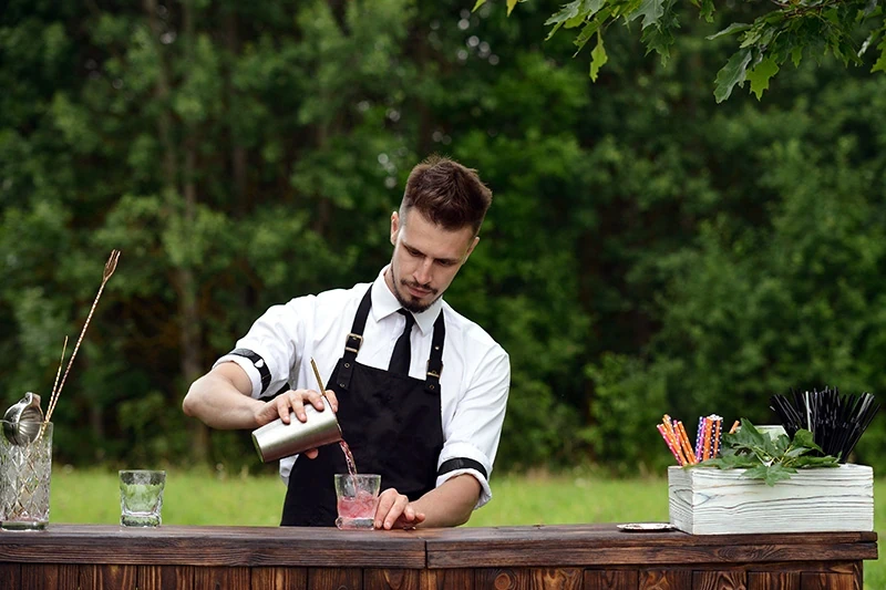 Bartender mixing a cocktail at an event bar