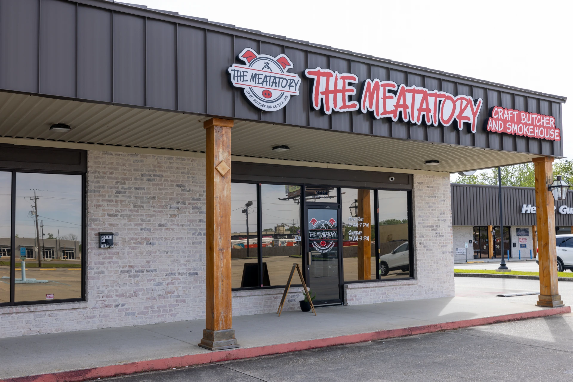 Exterior of The Meatatory storefront with the main sign above the entrance