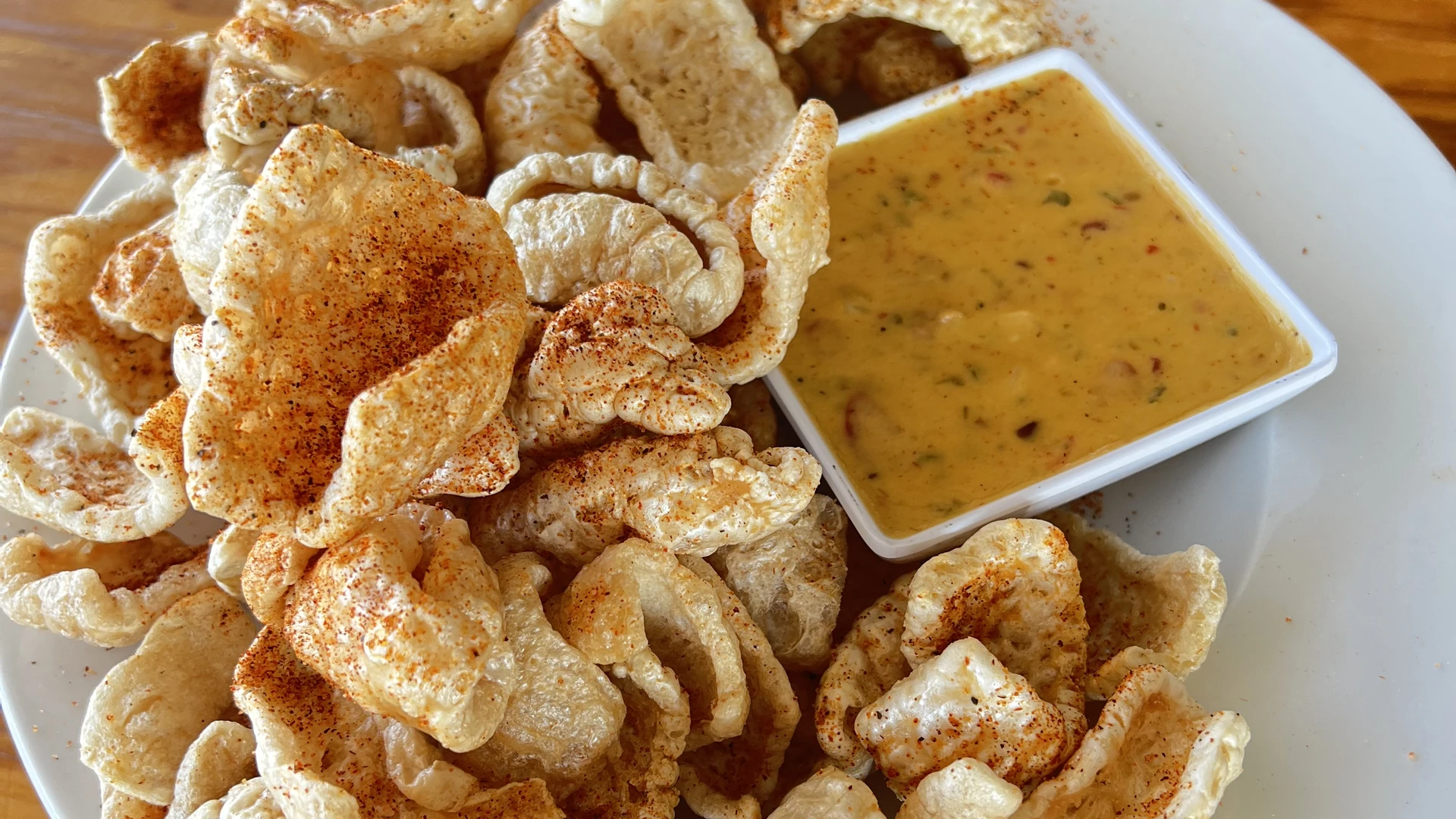 Seasoned pork rinds served with creamy Cajun dipping sauce.