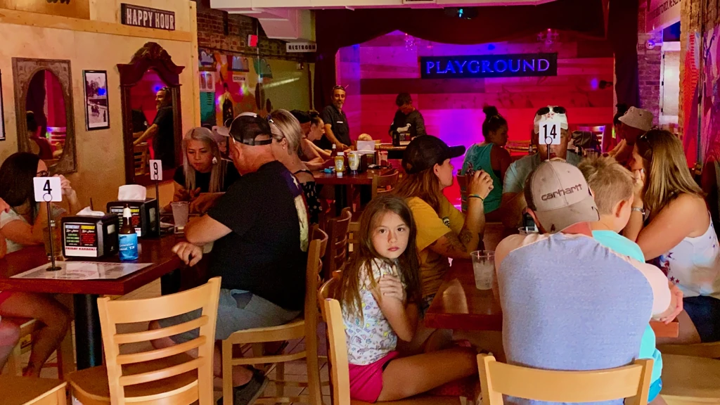 Guests dining inside PLAYGROUND BURGER BAR