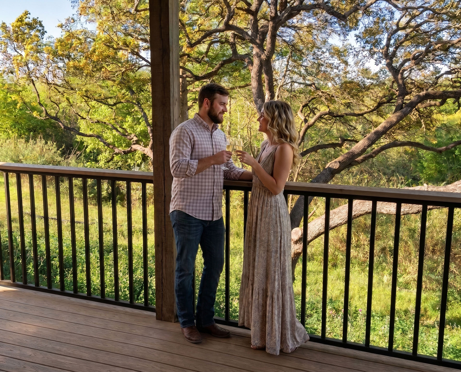 Couple toasting on the Carl Cottage balcony