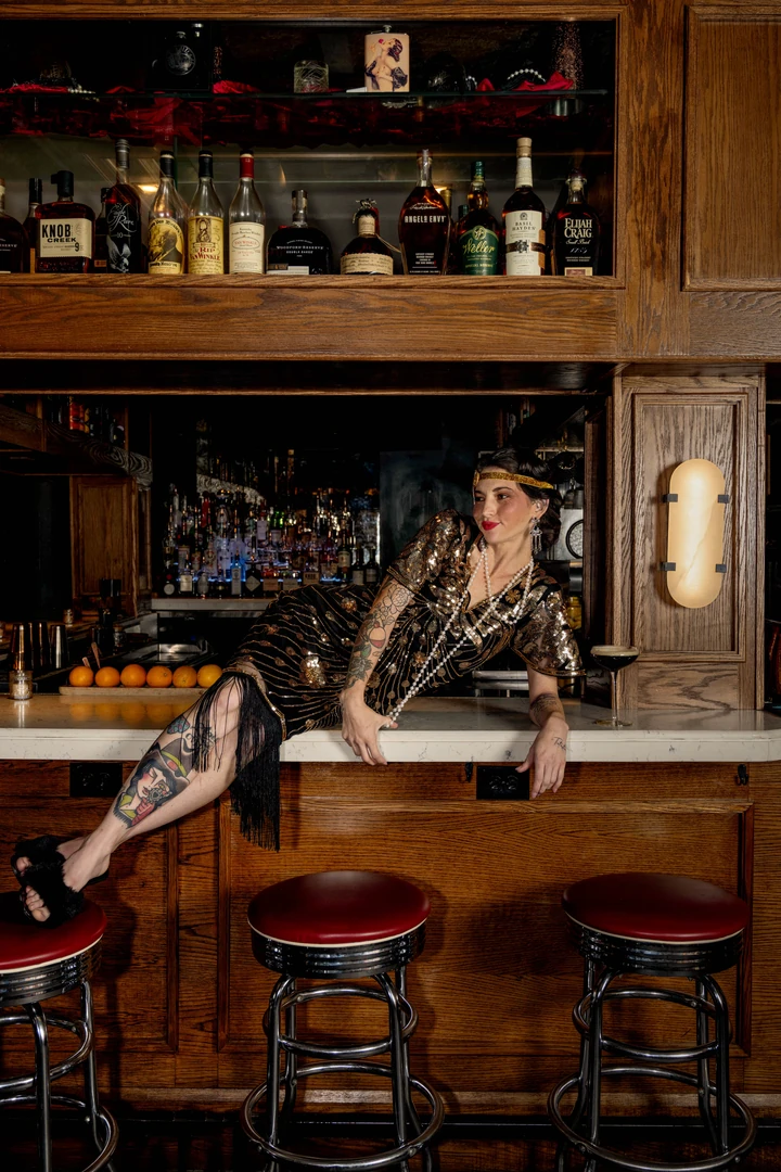 Bartender at work behind the U-shaped bar at The Bootlegger Speakeasy