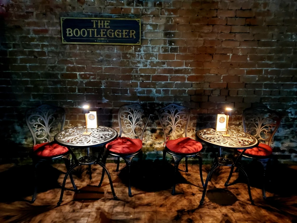 Candlelit tables set for a private event at The Bootlegger Speakeasy