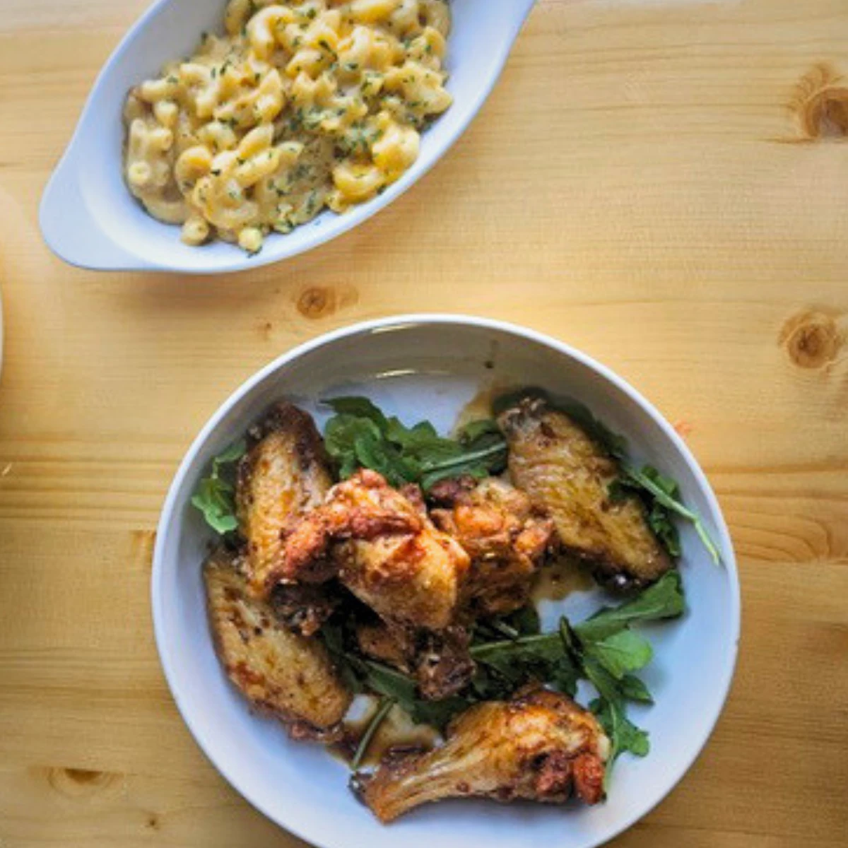Chicken wings with greens and mac and cheese at The Copper Table