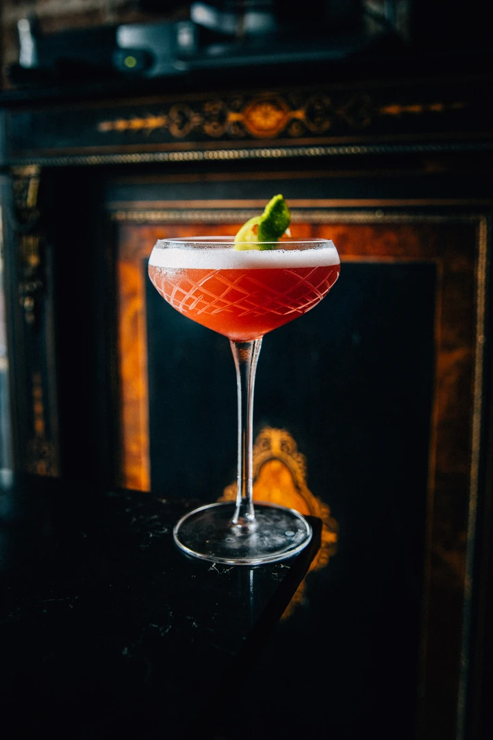 Coupe cocktail garnished with citrus at The Bootlegger Speakeasy
