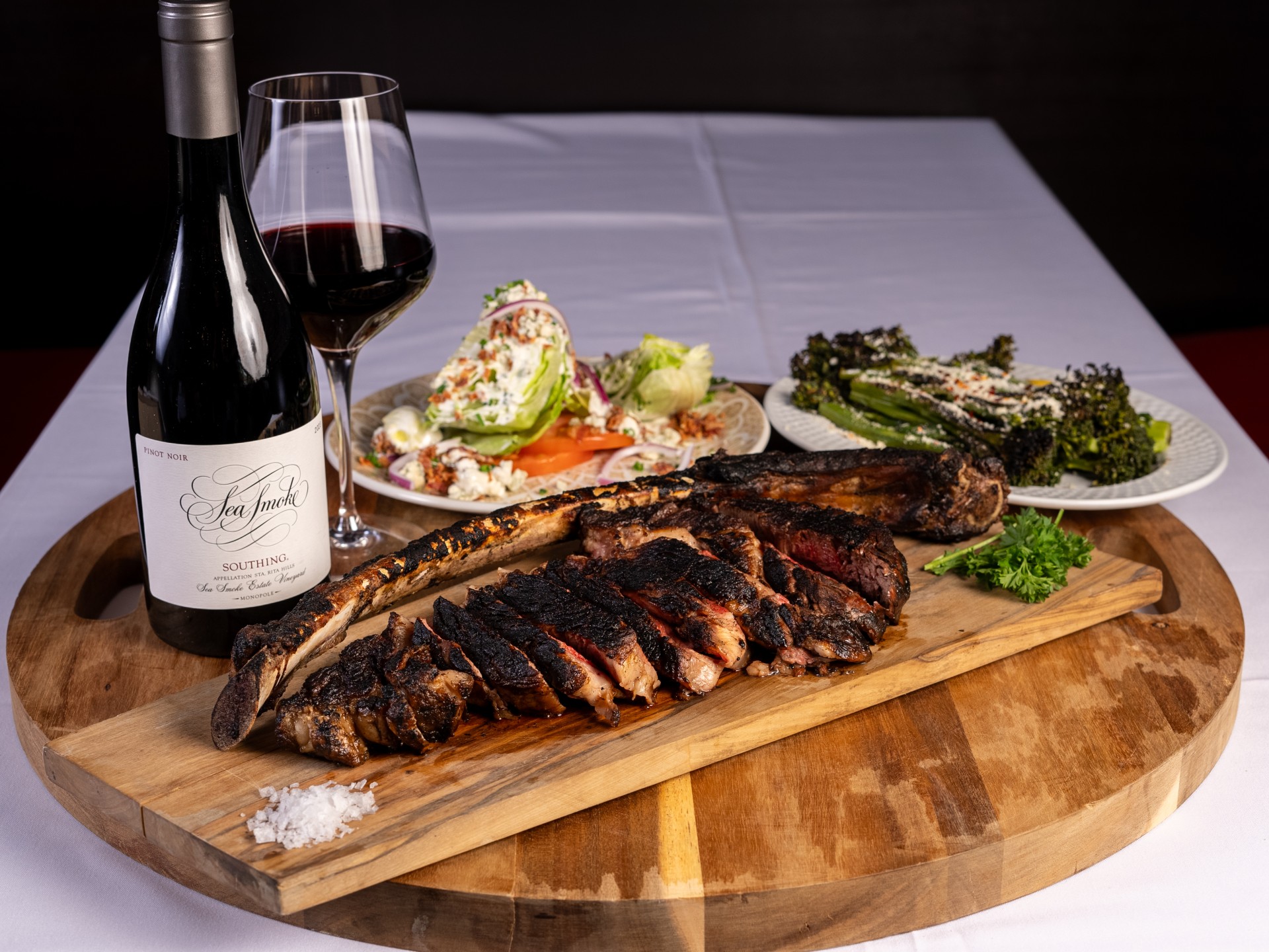Steakhouse dinner spread with wine