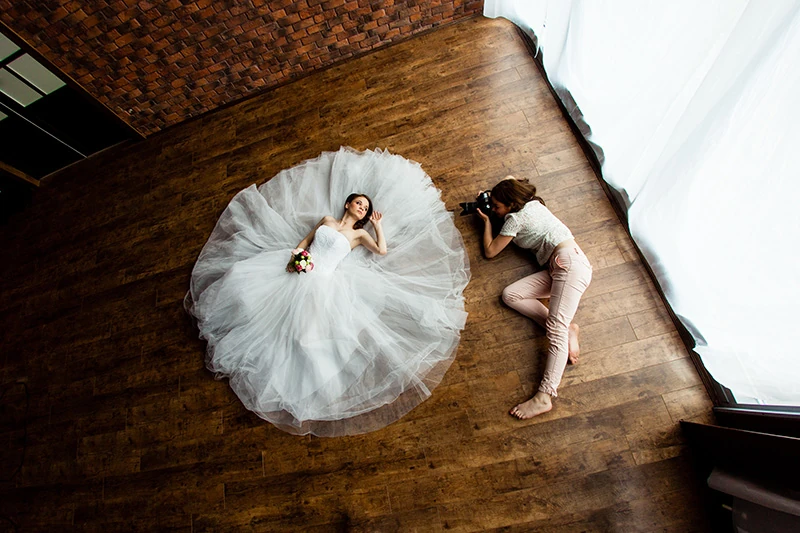 A wedding bride poses for a wedding photograph at the venue