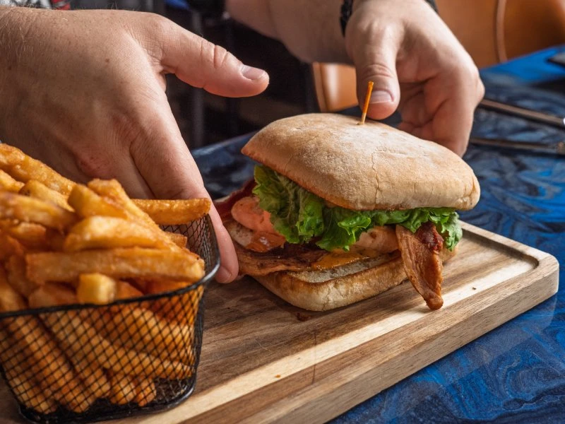 Sandwich with lettuce and bacon served with fries