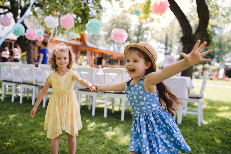 Two children play at a birthday party