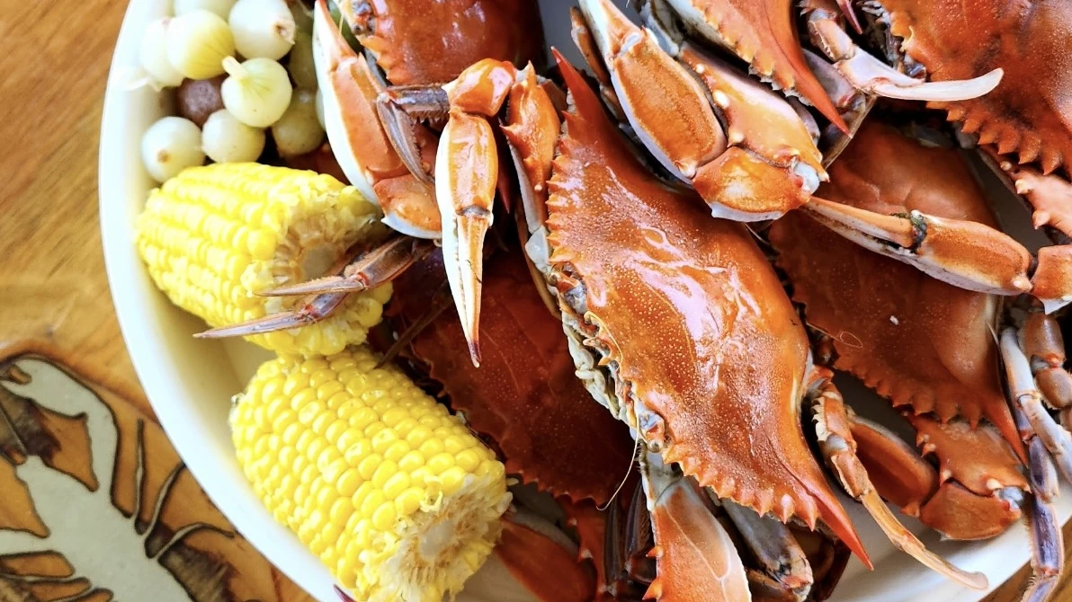Boiled blue crabs served with corn and baby potatoes.