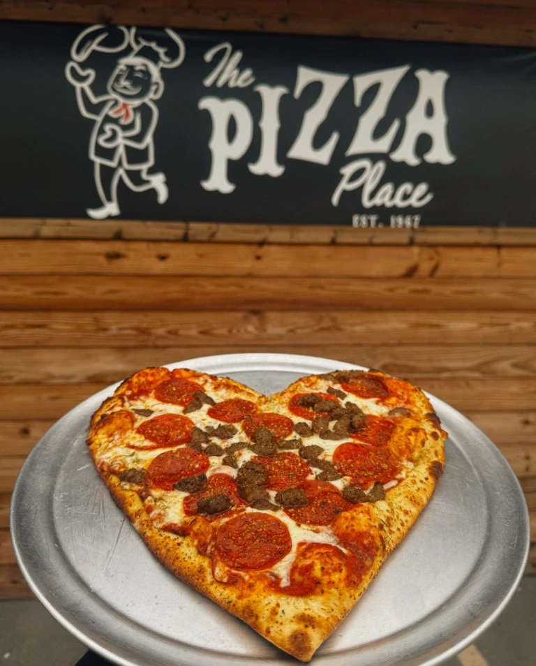 pizza with the pizza place logo in the background