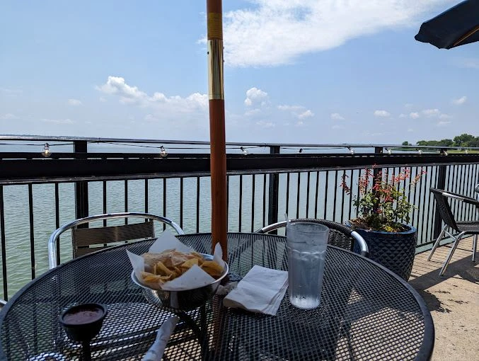 Patio table with chips and water overlooking the lake at Primo's Tex Mex Grille