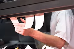 Staff member preparing an order at a counter