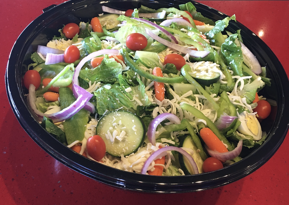 Our Party Garden Salad comes with romaine lettuce, tomatoes, cucumber, carrots, bell peppers, red onions, egg, cheese & croutons.