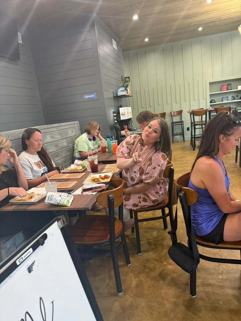 Guests enjoying lunch together inside Passion & Bliss during a casual group gathering in Leesburg, GA