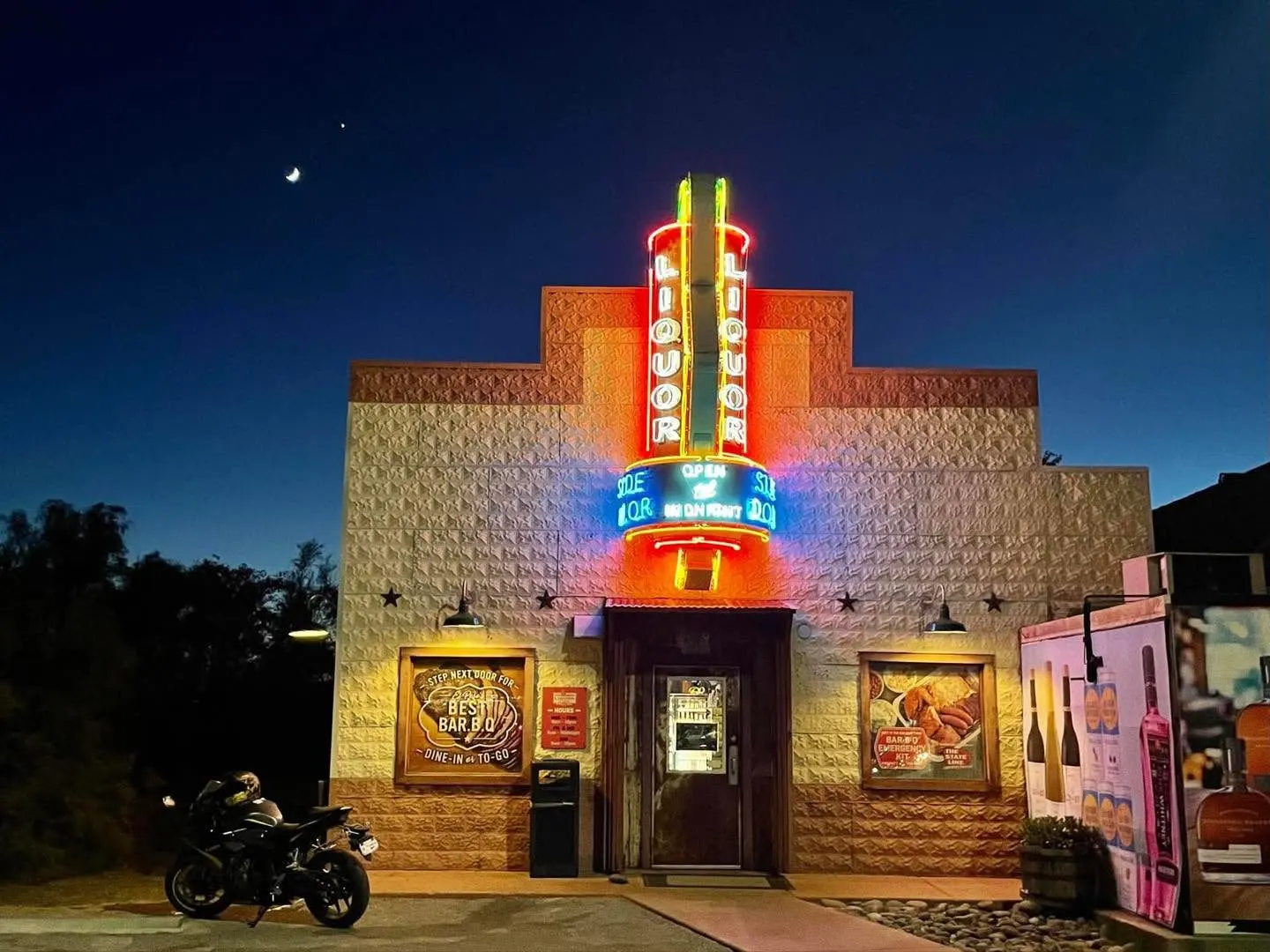 The Side Door Liquor Store neon sign lit at night in El Paso, Texas