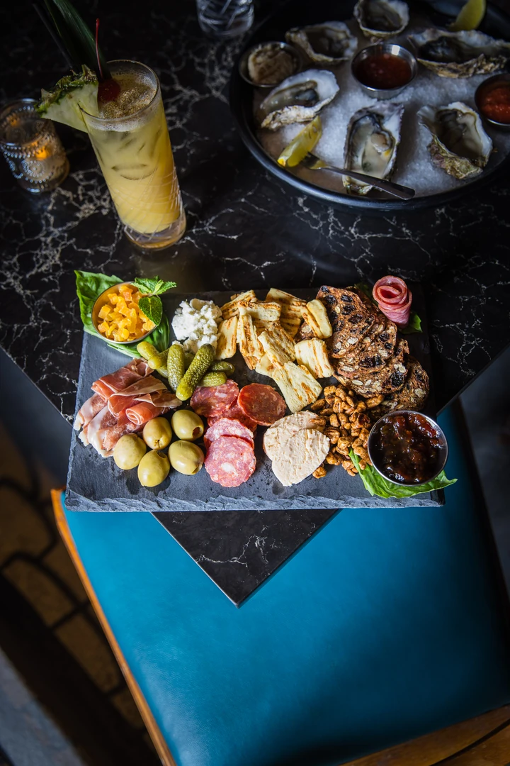 The Gatsby Charcuterie board with cured meats, cheeses and olives