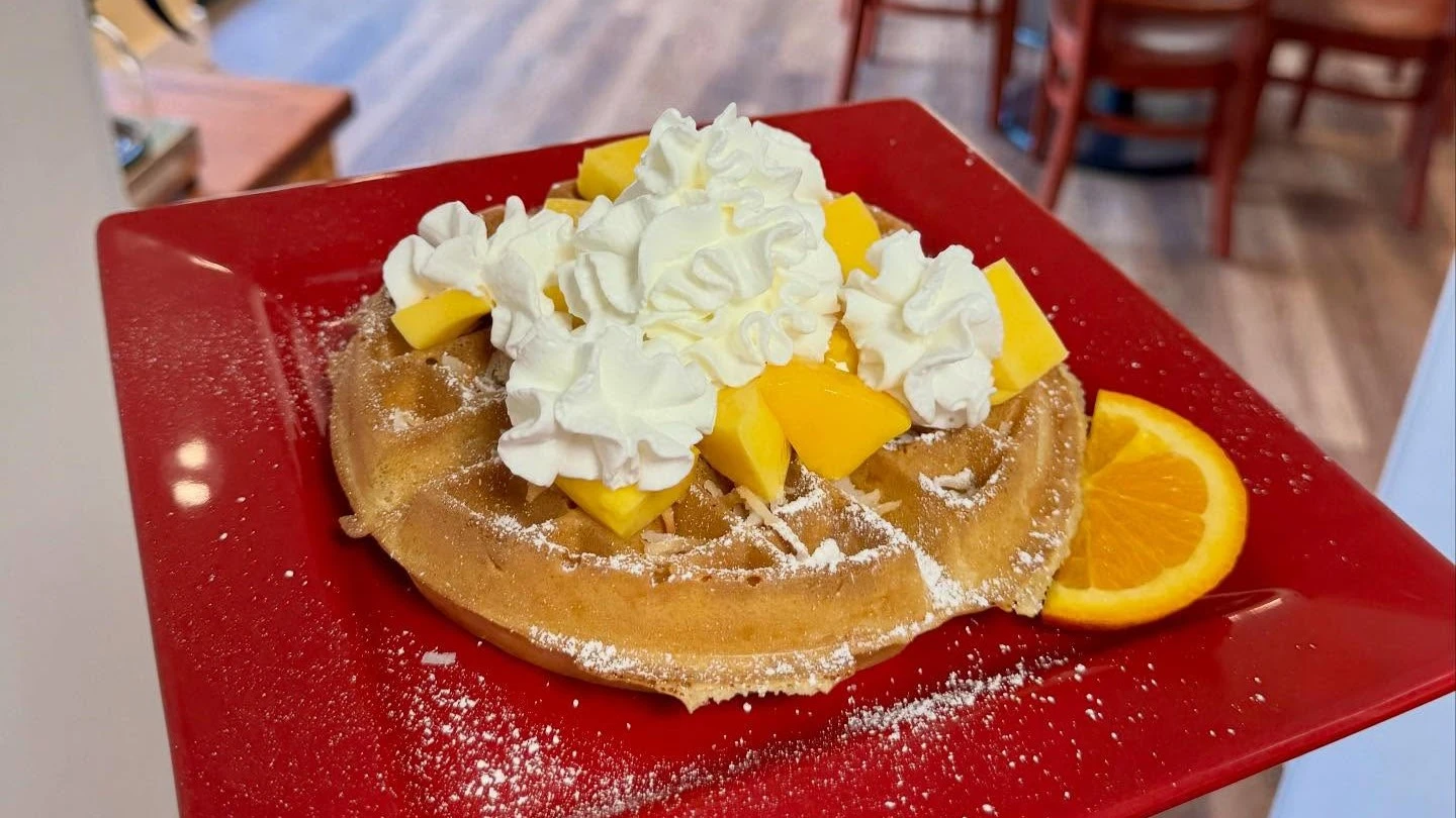 pancakes with whipped cream and mangos