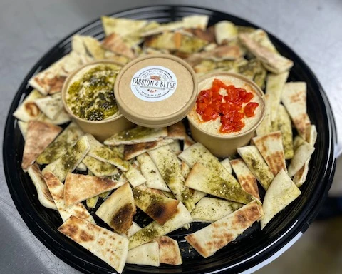 Catering platter with seasoned pita chips and three dips