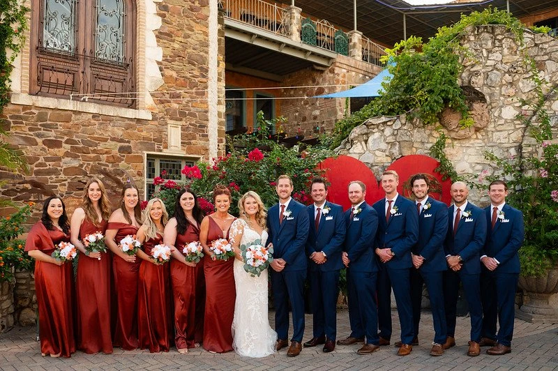 Wedding party in red and navy at The Oasis courtyard