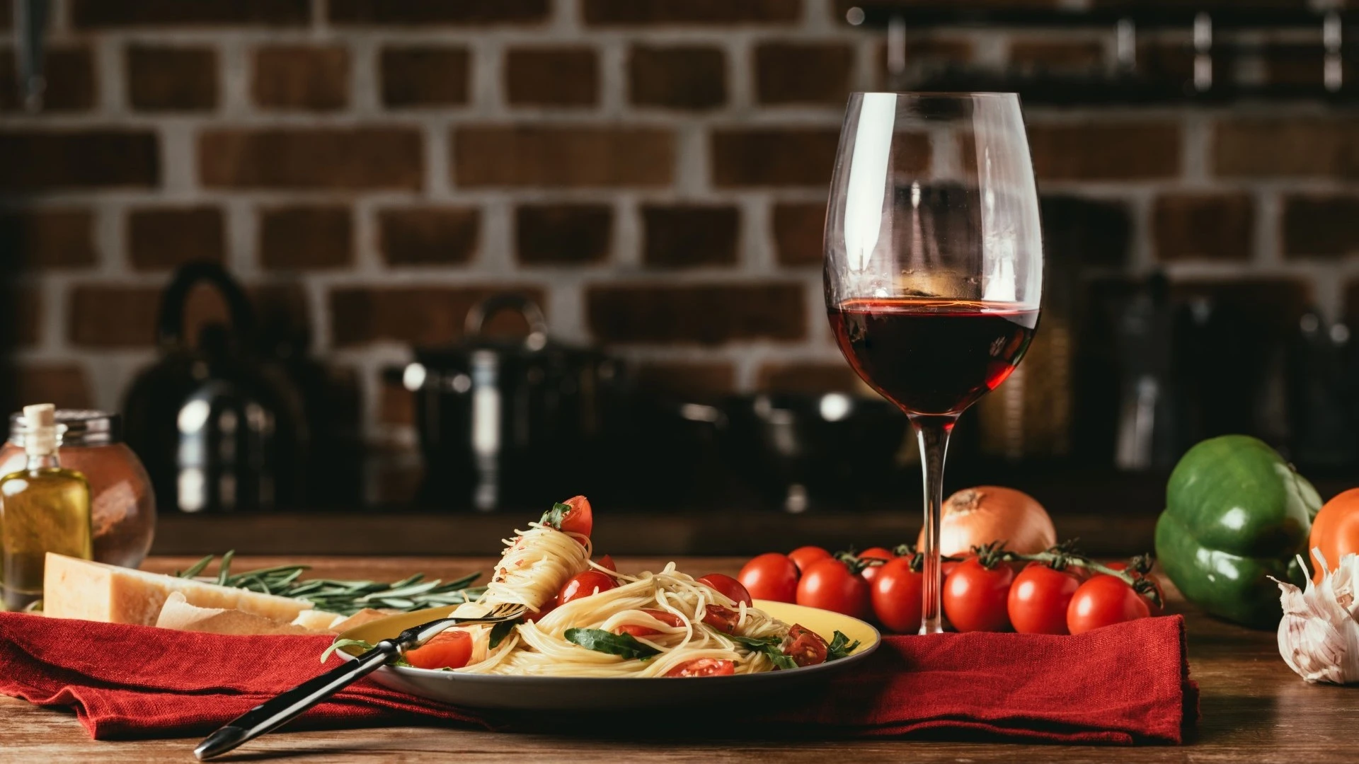 Italian food with a glass of wine on a red table cloth